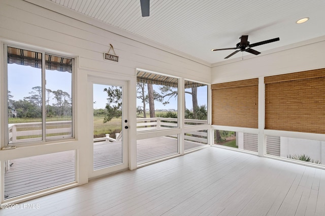 unfurnished sunroom with ceiling fan