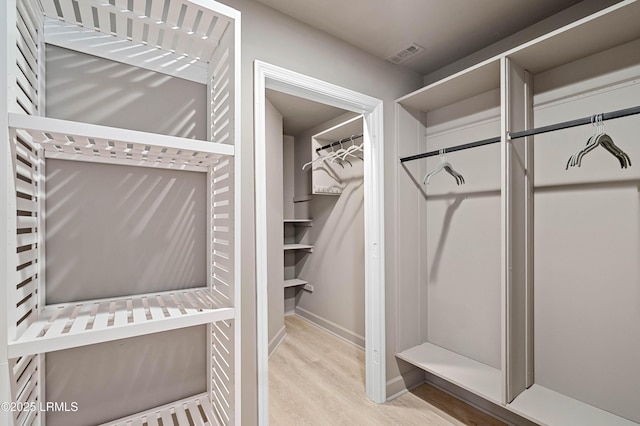 spacious closet with wood finished floors
