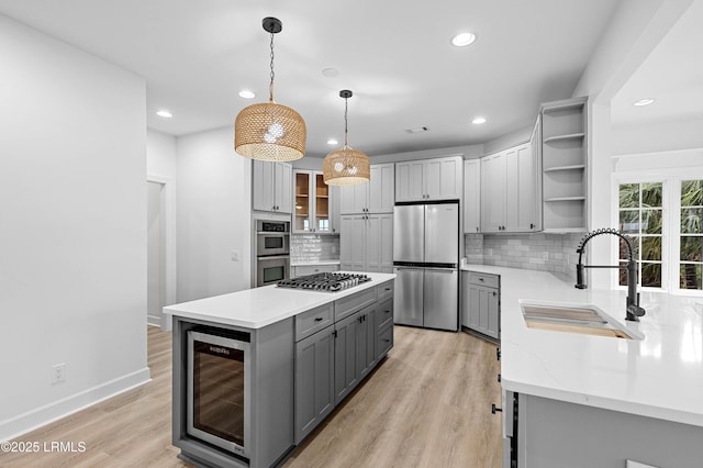 kitchen featuring appliances with stainless steel finishes, open shelves, a sink, gray cabinets, and wine cooler