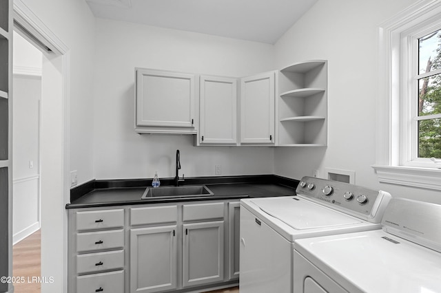 washroom featuring independent washer and dryer and cabinet space
