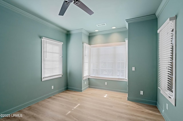 unfurnished bedroom with crown molding, wood finished floors, multiple windows, baseboards, and ceiling fan