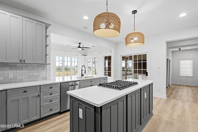 kitchen featuring gray cabinetry, stainless steel appliances, a sink, and recessed lighting