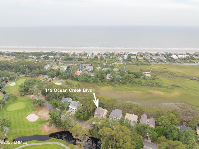 aerial view of property and surrounding area featuring a large body of water, nearby suburban area, and a golf club