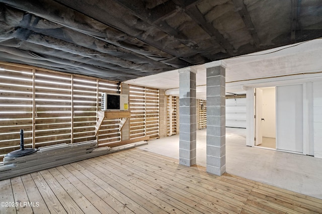 basement with hardwood / wood-style flooring