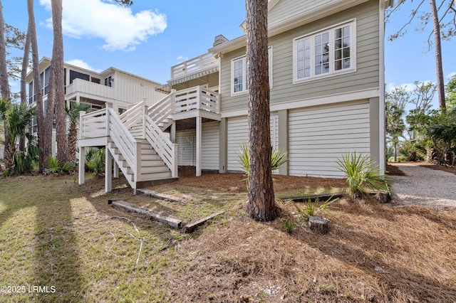 back of house with stairway and a deck