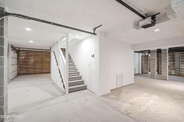 garage featuring a garage door opener and recessed lighting