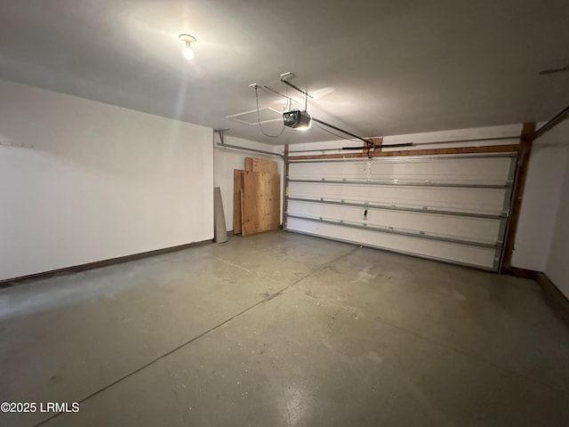 garage with baseboards and a garage door opener