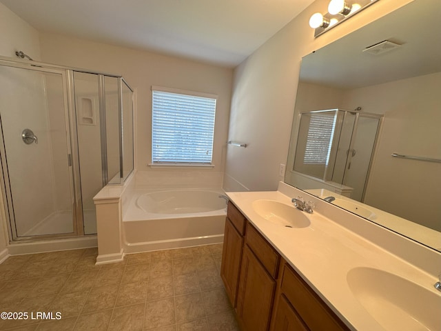 bathroom with double vanity, a sink, a shower stall, and a bath