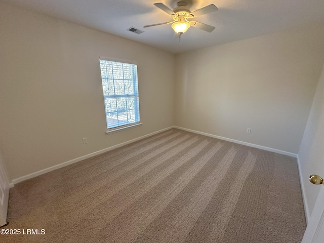 unfurnished room with a ceiling fan, carpet flooring, visible vents, and baseboards