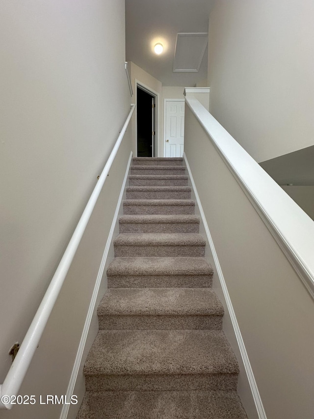 staircase featuring attic access