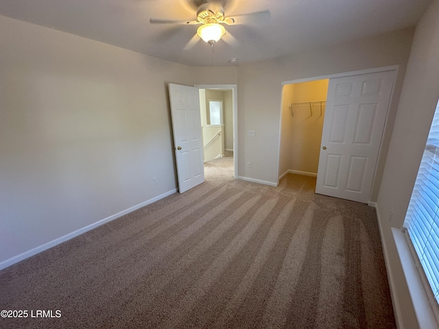 unfurnished bedroom featuring carpet floors, a closet, ceiling fan, and baseboards