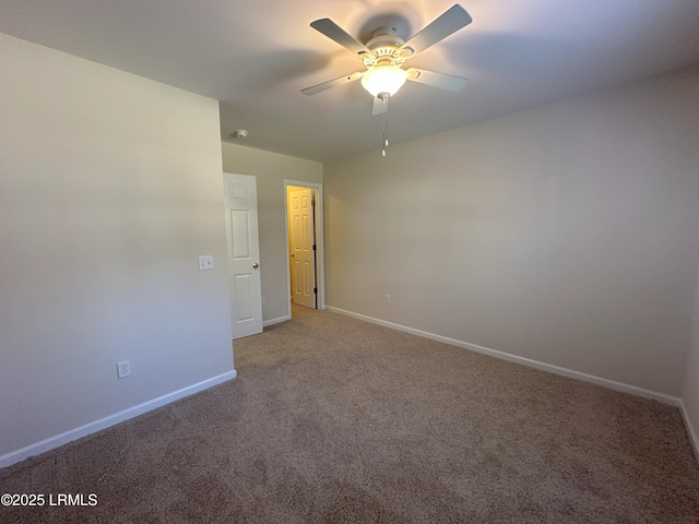 empty room featuring light carpet, ceiling fan, and baseboards