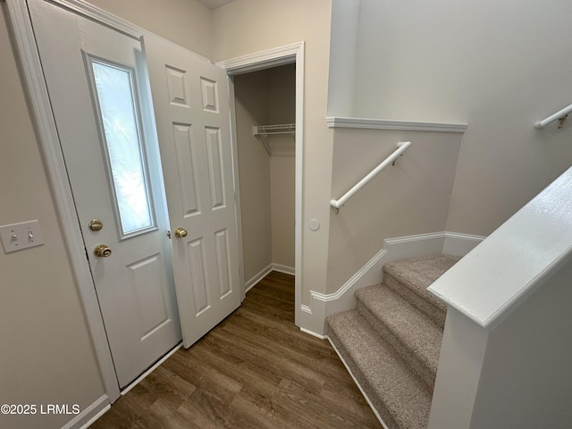 interior space featuring baseboards and wood finished floors