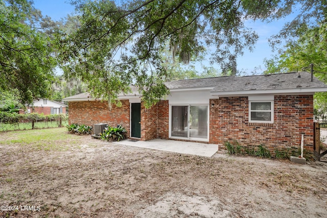 back of property with central AC and a patio area