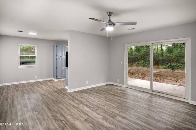 empty room with dark wood-type flooring and ceiling fan