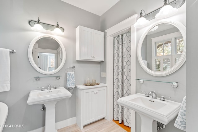 bathroom featuring hardwood / wood-style flooring and double sink