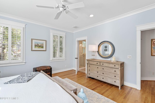 bedroom with crown molding, ceiling fan, connected bathroom, and light hardwood / wood-style floors