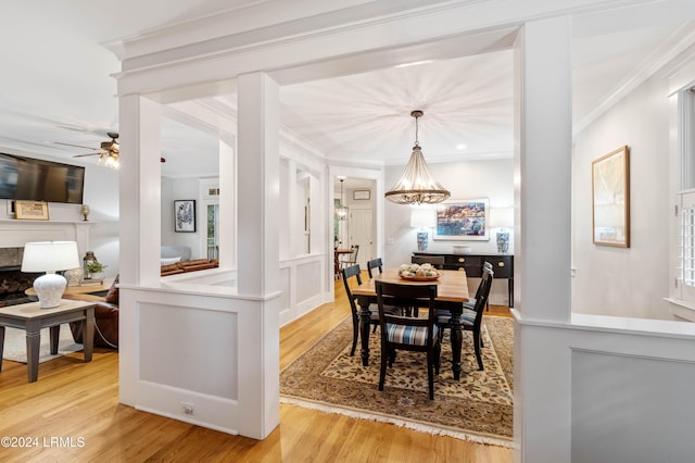 dining space with ornamental molding, ceiling fan, and light hardwood / wood-style flooring