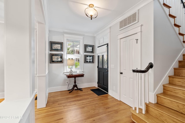 entrance foyer with crown molding and light wood-type flooring