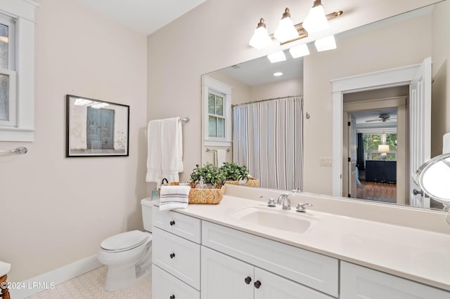 bathroom with vanity, tile patterned floors, toilet, and walk in shower