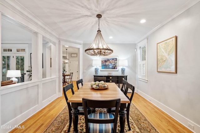 dining room featuring hardwood / wood-style floors, a notable chandelier, and ornamental molding