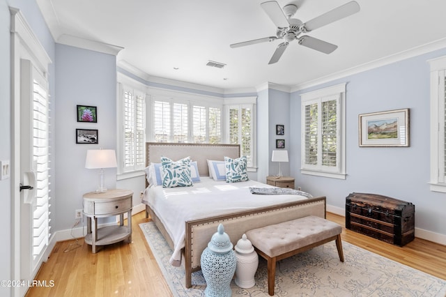 bedroom with hardwood / wood-style flooring, ceiling fan, and ornamental molding