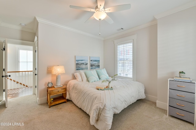 carpeted bedroom featuring ornamental molding and ceiling fan