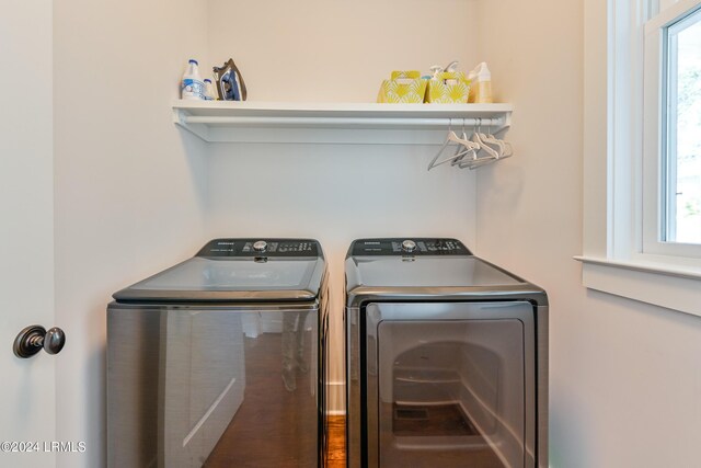 washroom with washing machine and clothes dryer and plenty of natural light