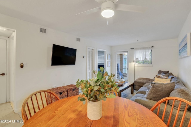 dining room with light tile patterned flooring and ceiling fan