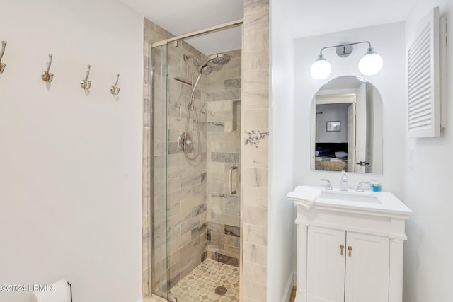 bathroom with vanity and a shower with shower door