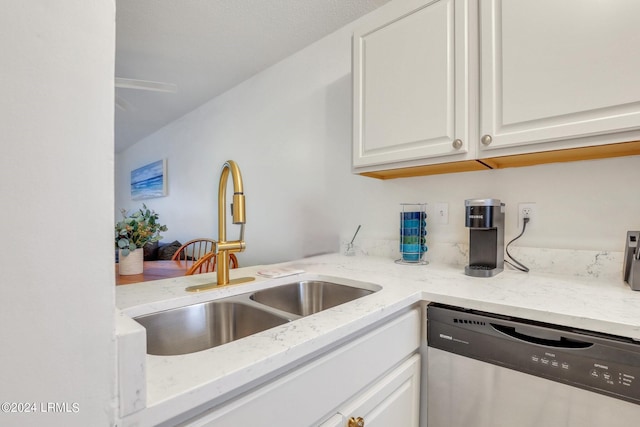 kitchen with white cabinetry, sink, light stone counters, and dishwasher