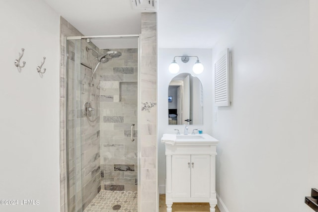 bathroom featuring vanity and an enclosed shower