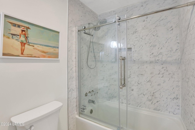 bathroom featuring enclosed tub / shower combo and toilet