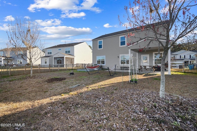 back of property with fence and a residential view