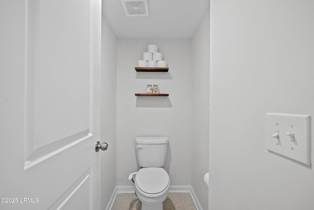 bathroom with baseboards, visible vents, and toilet