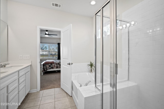 bathroom featuring visible vents, a bath, ensuite bath, tile patterned floors, and a sink