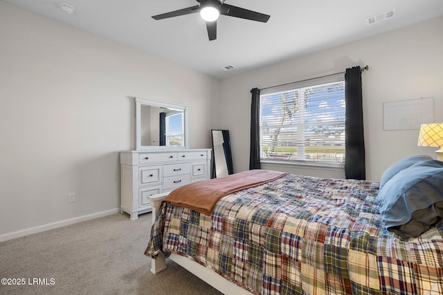 bedroom with baseboards, a ceiling fan, visible vents, and light colored carpet