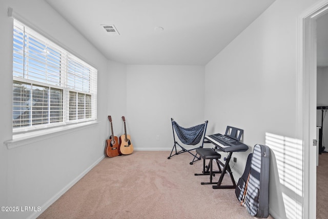 office area featuring light carpet, baseboards, and visible vents