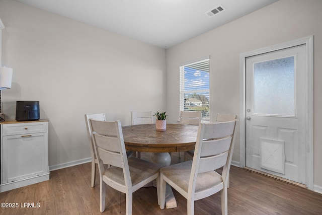 dining area with light wood-style floors, visible vents, and baseboards