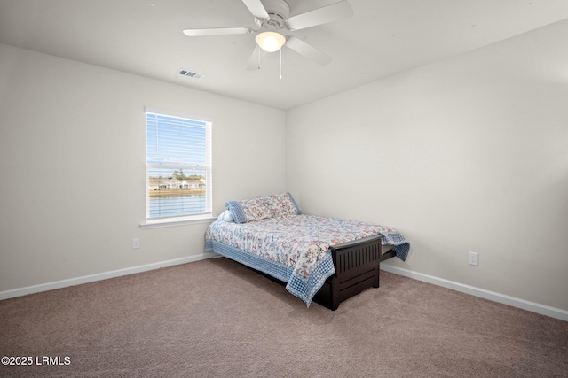 bedroom featuring a ceiling fan, baseboards, visible vents, and carpet flooring