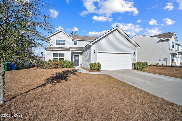 traditional-style house featuring a front lawn, driveway, and an attached garage