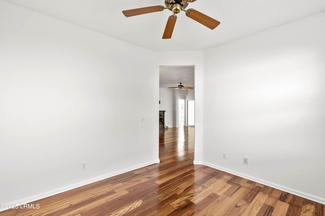 spare room with wood finished floors and baseboards