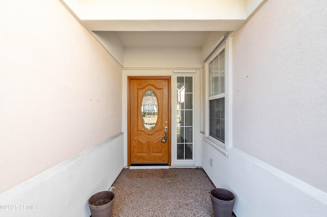 view of exterior entry with stucco siding