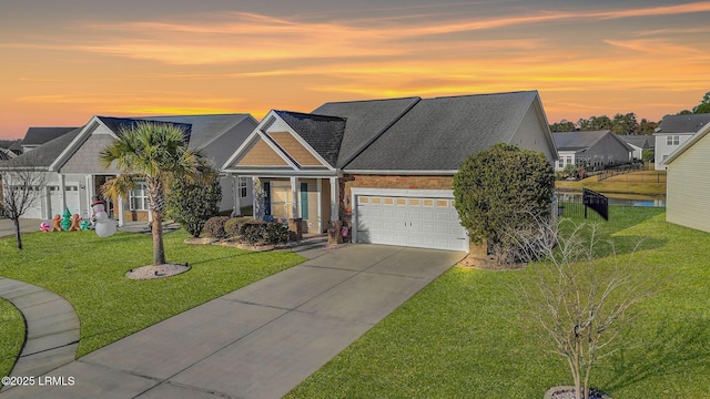 craftsman-style house featuring a yard and a garage