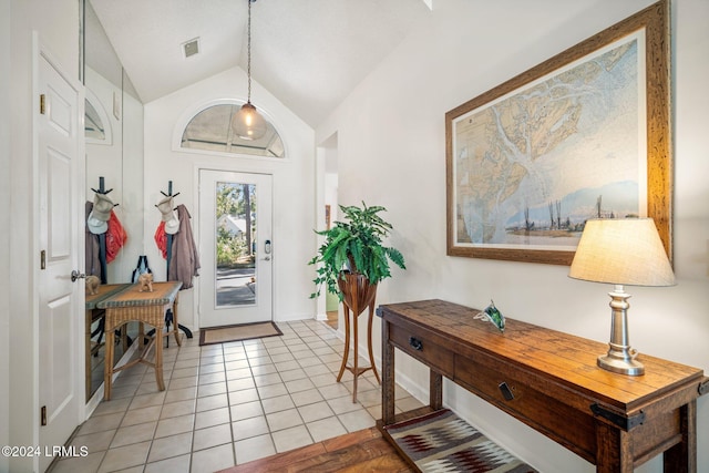 foyer with lofted ceiling and light tile patterned floors