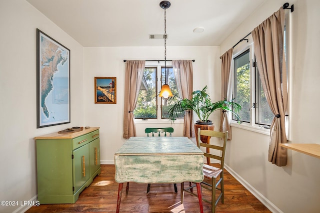 dining room with dark wood-type flooring