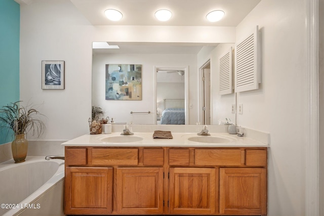 bathroom featuring vanity and a tub