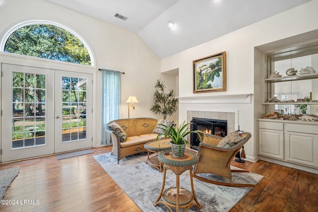 sitting room featuring hardwood / wood-style flooring, plenty of natural light, and french doors