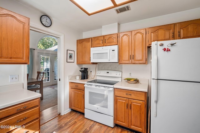 kitchen featuring french doors, white appliances, and light hardwood / wood-style flooring