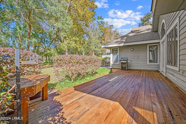 wooden terrace with a grill